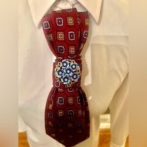 Red and Blue Patterned Tie with Floral Pin